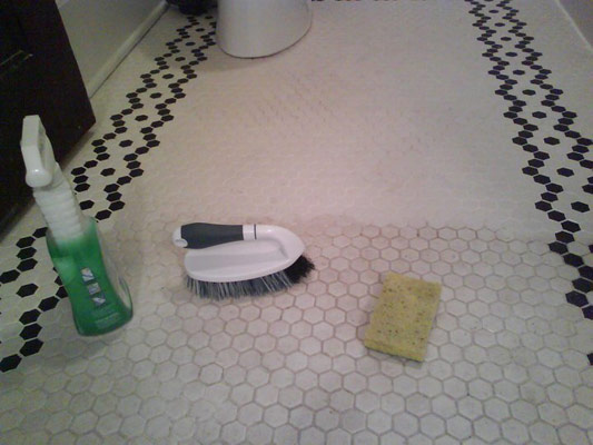 A dirty floor in the process of becomming squeaky clean